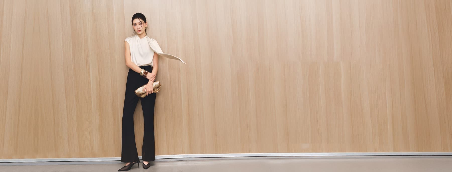 MYAN Parisian Office campaign with a woman in black tailored trousers